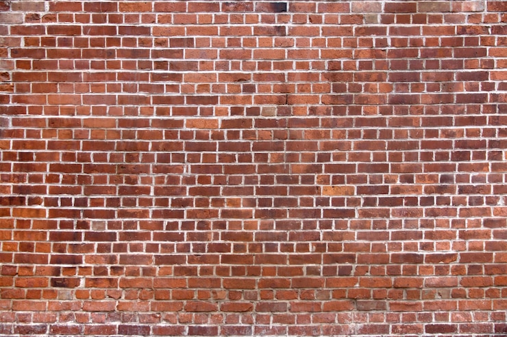 Photo gratuit mur de briques avec une nouvelle brique