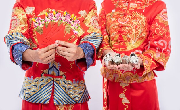 Le nouvel an chinois, de l'argent cadeau et de l'argent seront obtenus - donnez aux hommes et aux femmes des vêtements traditionnels Cheongsam