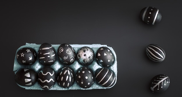 Oeufs de Pâques dans un bac sur une table isolée noire