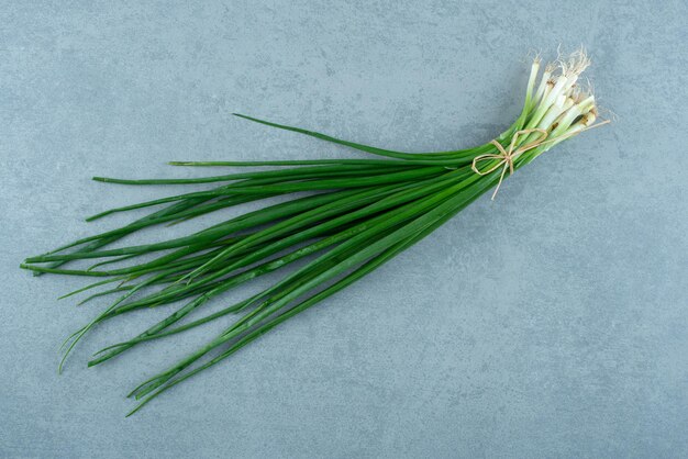 Oignons de printemps frais sur marbre.