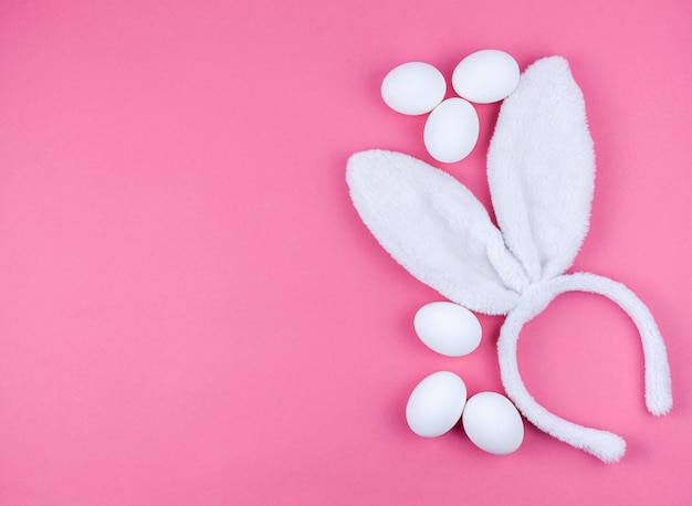 Photo gratuite oreilles de lapin avec des oeufs blancs sur la table