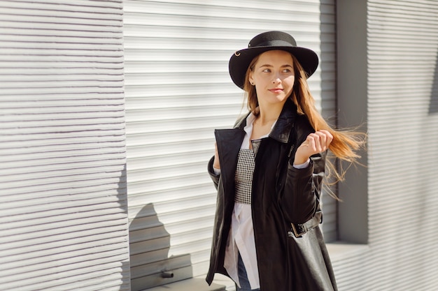 Photo gratuite Ã â oung jolie fille se promène dans la ville en souriant et posant