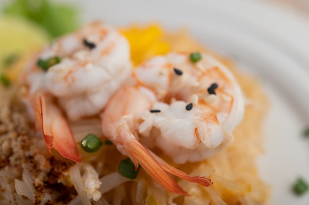 Pad Thai crevettes fraîches dans une assiette blanche.