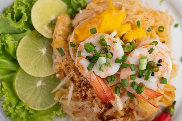 Pad Thai crevettes fraîches dans une assiette blanche.