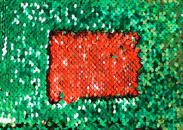 Photo gratuite paillettes rouges à l'intérieur des paillettes réfléchissantes vert foncé scintillant