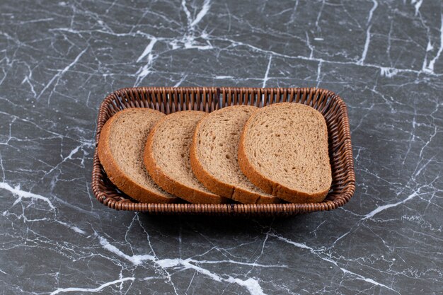 Pain de mie dans le bol à pain, sur la surface en marbre