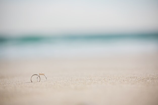 Paire de bague de mariage sur le sable