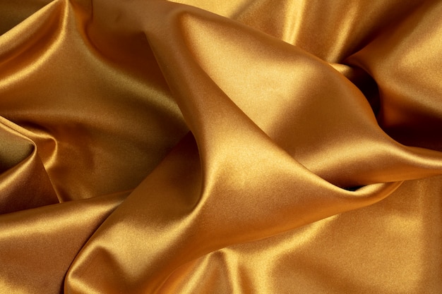 Photo gratuite papier peint esthétique doré avec vue de dessus en tissu