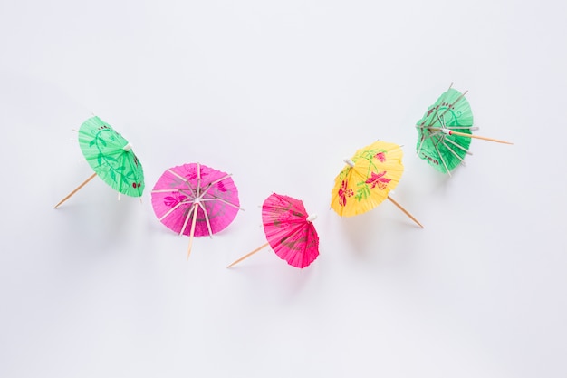 Parapluies cocktail lumineux sur la table blanche