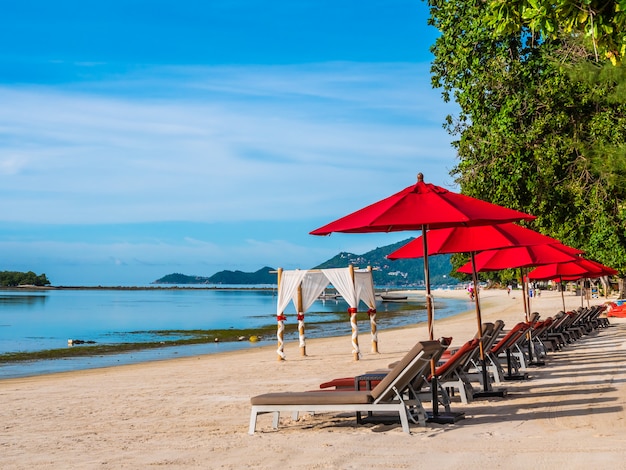 Parasol et chaise sur la plage tropicale mer et océan