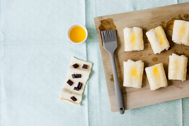 Pâte feuilletée crue maison pliée sur une planche à découper en bois