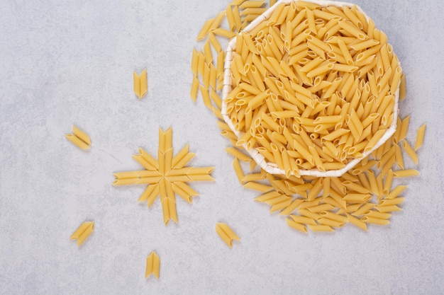 Pâtes Rigatoni Crues Dans Un Bol Blanc.