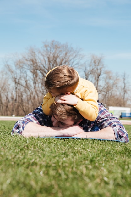 Père barbu se trouve à l'extérieur avec son fils dans le parc