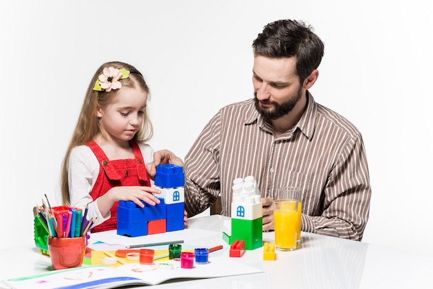 Père et fille jouant ensemble à des jeux éducatifs