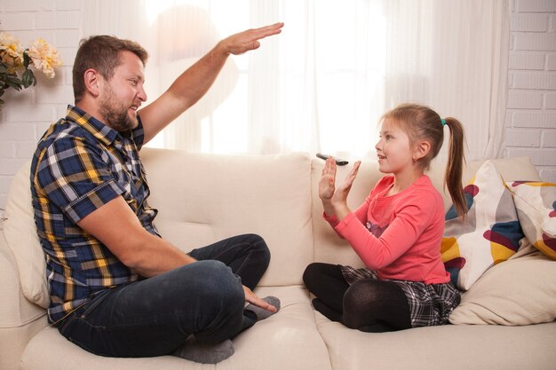 Père et fille jouant avec les mains