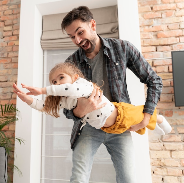 Photo gratuite père jouant avec une fille