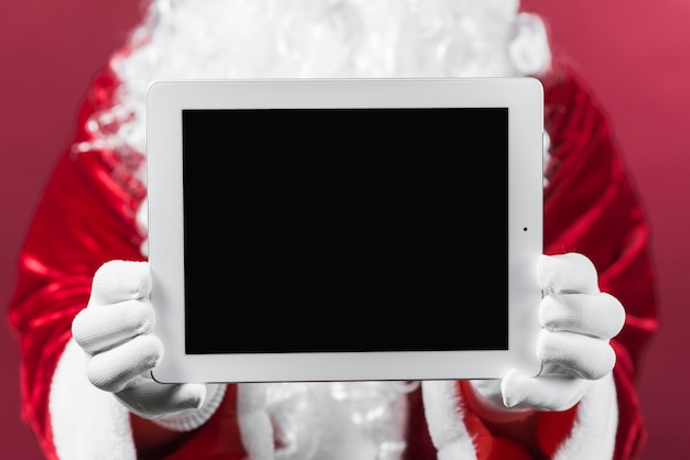 Père Noël tenant la tablette en mains