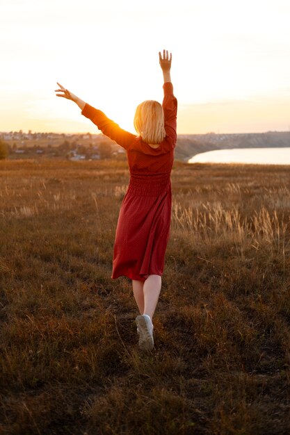 Personne appréciant le coucher du soleil chaud et nostalgique