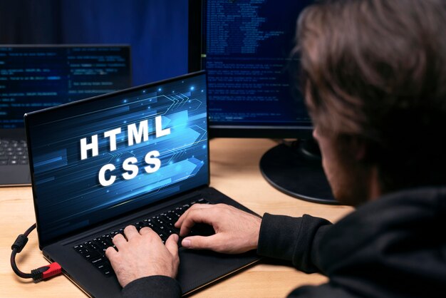 Personne devant l'ordinateur travaillant HTML