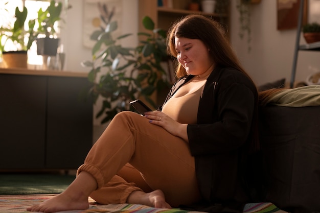 Photo gratuite personne de grande taille faisant des activités à l'intérieur de la maison