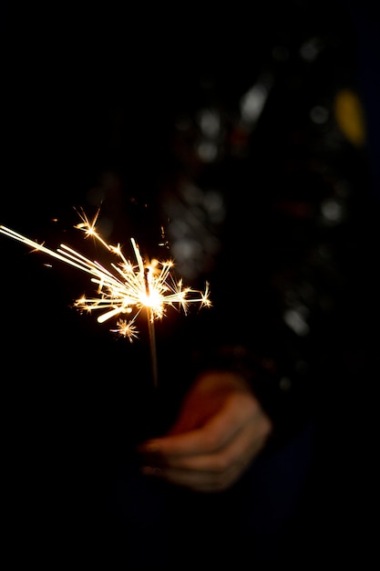 Personne tenant un cierge magique festif