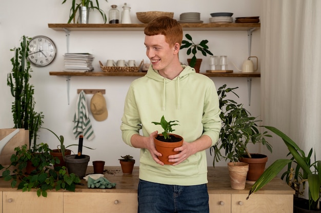 Photo gratuite personne transplantant des plantes dans de nouveaux pots