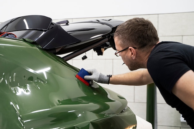 Personne travaillant sur l'habillage de voiture