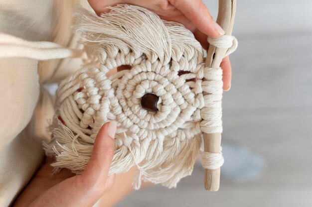 Personne utilisant la technique du macramé à l'intérieur