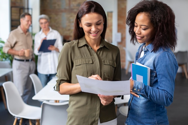 Personnes utilisant un appareil numérique lors d'une réunion