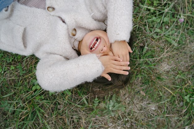 Petit enfant dans un joli pull blanc. Fille passer du temps dans un parc