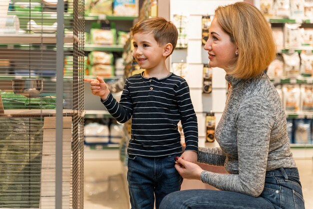 Petit garçon vérifiant les produits de l'animalerie