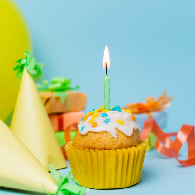 Petit gâteau sucré avec un gros plan de bougie allumée