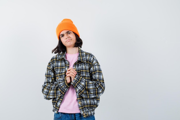 Photo gratuite petite femme montrant les mains jointes dans un geste de plaidoirie en t-shirt à l'espoir