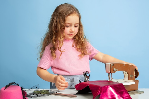 Photo gratuite petite fille rêvant du futur métier de couturière