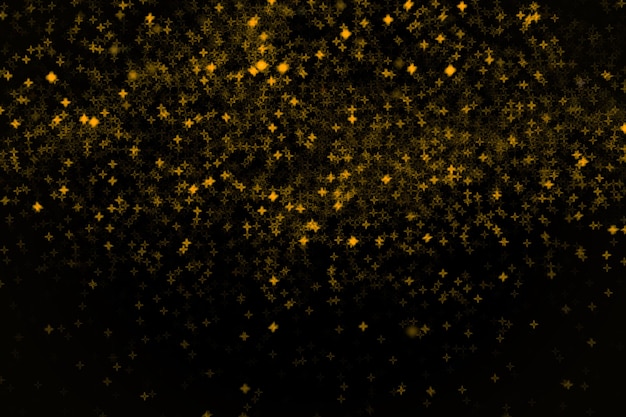 Les petites étoiles jaunes et dorées brillantes et foncées brouillent l'élément de conception noir bokeh pour la superposition