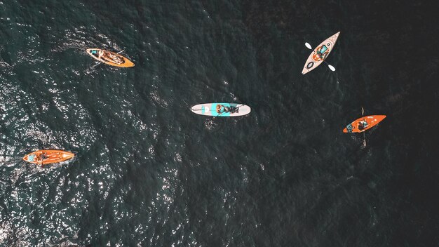 Photo aérienne de personnes dans de petites barques dans l'eau