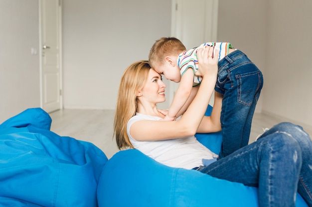 Photo de Studio d'une mère jouant avec son enfant. Maman tient le garçon dans ses bras