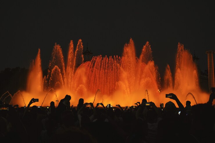 Photographie de silhouette de personnes devant une fontaine d'eau