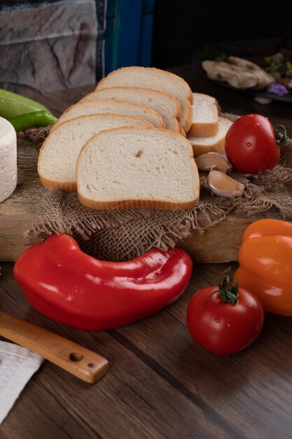 Piments rouges et pain sur une table en bois