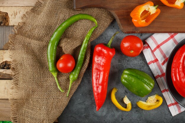 Piments sur une toile de jute sur un morceau de bois.