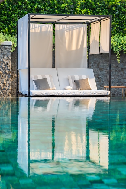 Piscine en plein air avec chaises longues et parasols pour les voyages d&#39;agrément