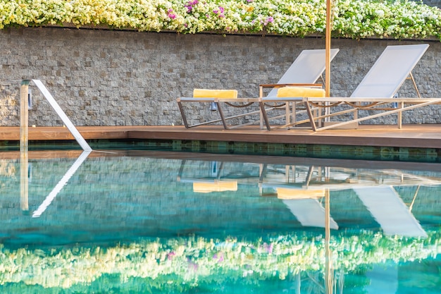 Piscine en plein air avec chaises longues et parasols pour les voyages d&#39;agrément