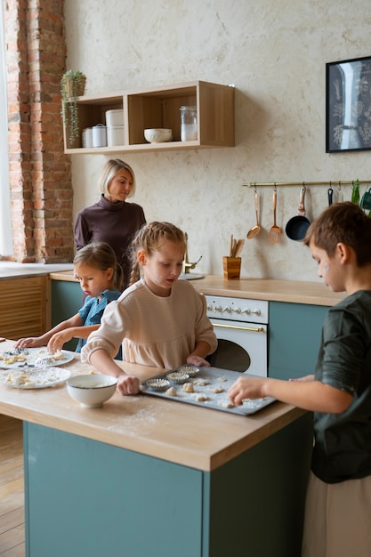 Photo gratuite plan moyen d'enfants cuisinant dans la cuisine