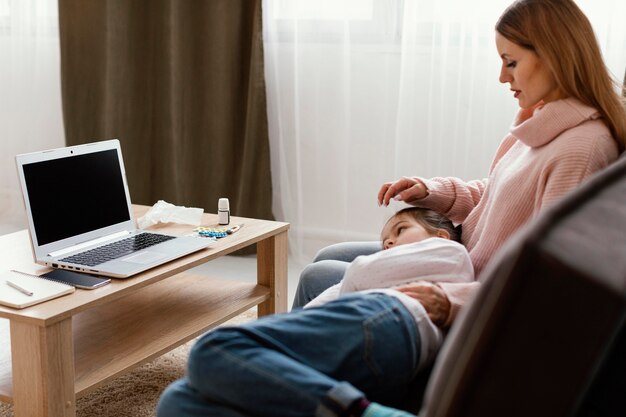 Plan moyen femme et enfant sur canapé