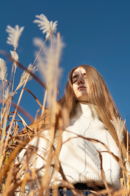 Photo gratuite plan moyen femme posant à l'extérieur