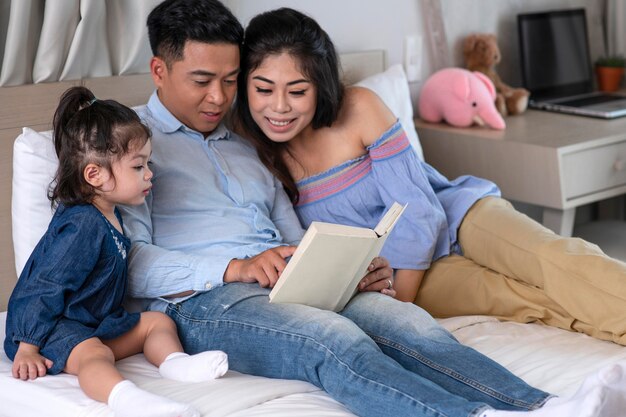 Plan moyen parents lisant à l'enfant