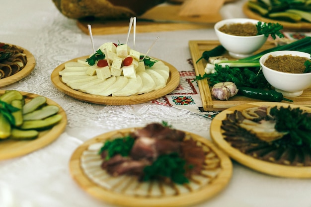 Plateaux en bois avec des collations se tiennent sur la table blanche