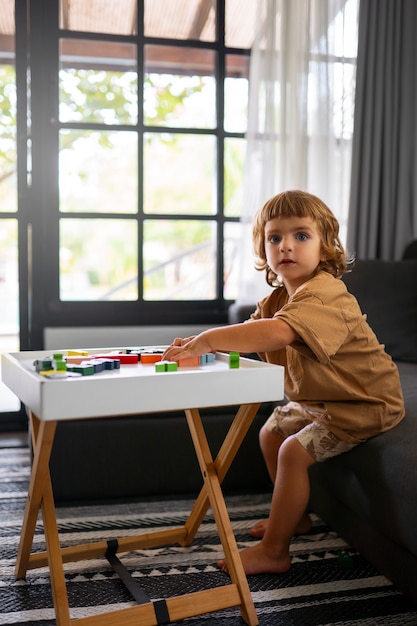 Photo gratuite plein coup enfant assis sur un canapé