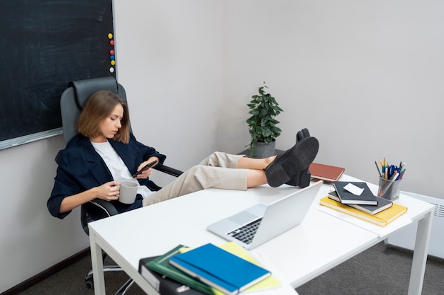 Plein coup femme défilant sur téléphone au travail