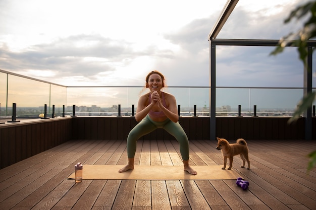 Photo gratuite plein coup femme faisant du sport accompagné d'un chien